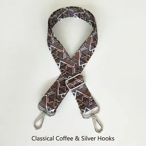Detail of ethnic geometric pattern bag strap with silver lobster hooks and adjustable buckle