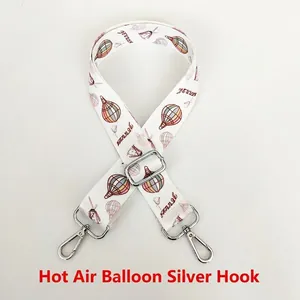 Detail of hot air balloon pattern bag strap with adjustable silver metal hooks