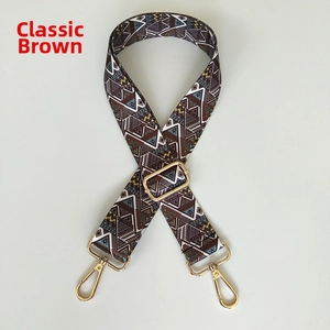 Close-up of bohemian geometric bag strap with golden metal hooks and adjustable buckle