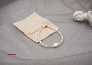 Detail of freshwater mini pearl bracelet featuring a unique heart-shaped pearl and gold clasp