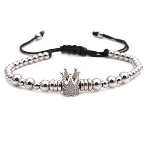Detail of silver beaded bracelet with sparkling crown charm and adjustable black cord