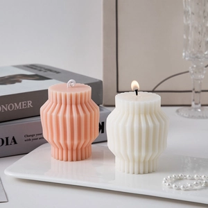 Modern geometric column scented candles in pink and cream on a decorative white tray