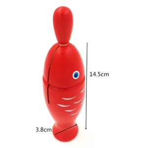 Detail view of red wooden fish percussion instrument showing 14.5cm height dimension