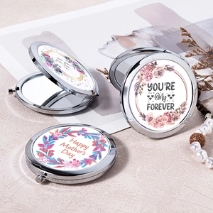 Three silver folding pocket makeup mirrors with assorted floral patterns and greetings