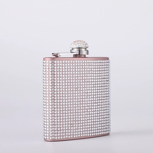 Rose gold stainless steel hip flask covered in sparkling rhinestones with a matching cap