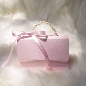 Elegant pink embossed candy gift box featuring a pearl handle and pink ribbon bow