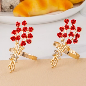 Rose flower napkin rings with red petals and gold leaves featuring rhinestone bow accents