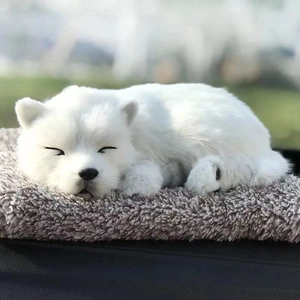 Close-up of a white plush cat doll sleeping peacefully with soft long faux fur texture
