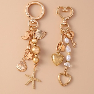 Golden keychain set with moon, starfish, shell, heart charms and elegant pearl beads