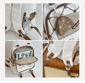 Detail views of white nylon backpack with side pockets and mini mushroom coin purse accessory