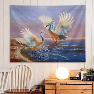 Detail of wall tapestry featuring cranes flying over deep blue sea at pink sunset