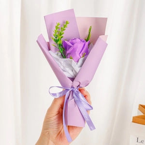 Close-up of mini purple soap rose bouquet with Just for you ribbon and lavender paper