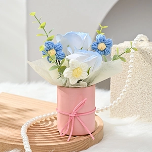 Artificial blue and white soap flower bouquet in a pink gift box with ribbon