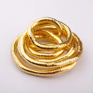 Detail of a 90cm flexible gold snake bone necklace showing the coiled metal texture