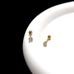 Macro shot of 0.8mm gold-plated titanium steel stud with a sparkling round cubic zirconia