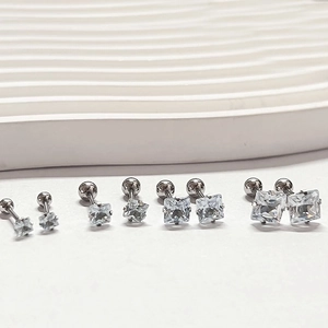 Detail of four-prong square zircon stud earrings with screw-back balls in varied sizes