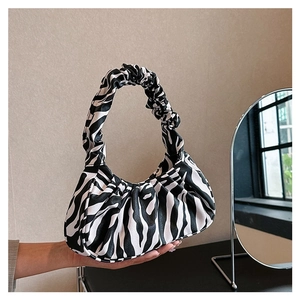 Detail view of the zebra print cloud bag featuring unique pleats and soft PU leather