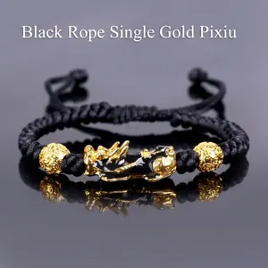 Detail of hand-woven black cord bracelet featuring a gold PiXiu and lucky beads