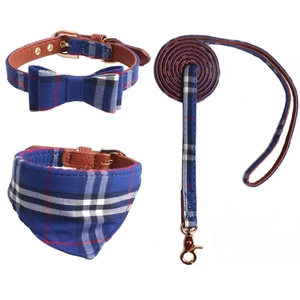 Detail of British style navy plaid dog harness set with leather lining and gold hardware
