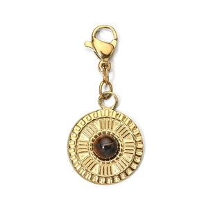 Close-up of a gold stainless steel pendant featuring a brown gemstone and lobster clasp