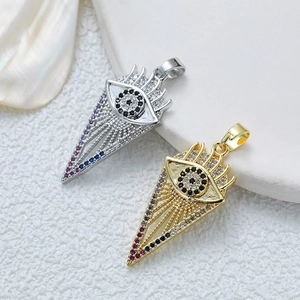 Close-up of gold and silver evil eye pendants with zircon inlays and colorful stones