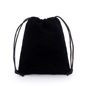 Detail of soft black velvet texture and drawstring closure on a jewelry storage pouch