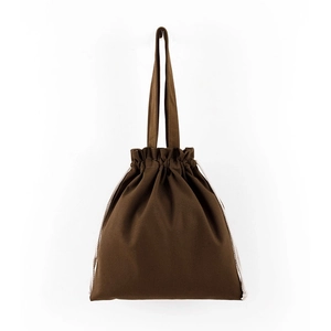 Detail of brown cotton canvas tote bag featuring double handles and drawstring closure