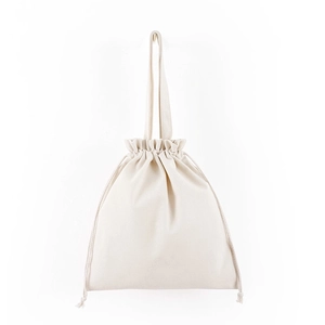 Detailed close-up of beige canvas drawstring bag with shoulder strap and clean fabric texture