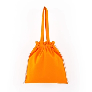 Close-up of vibrant orange canvas drawstring bag with sturdy handles and neat stitching