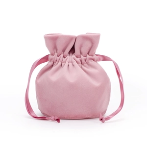 Detailed view of a pink velvet drawstring pouch with matching satin ribbons for jewelry
