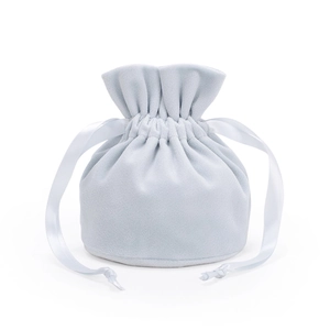 Detail of light blue velvet drawstring jewelry bag with soft texture and silk ribbons