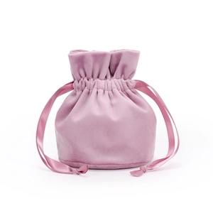 Detailed view of pink velvet drawstring pouch with soft texture and ribbon closure
