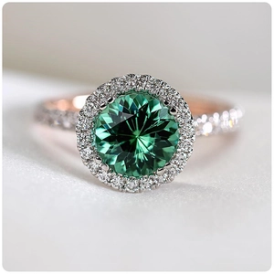 Luxurious rose gold halo ring with a round emerald green gemstone and micro-paved zircons