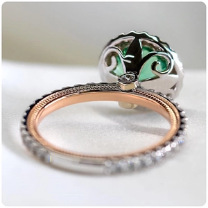 Macro detail of silver and rose gold ring with green zircon and filigree base