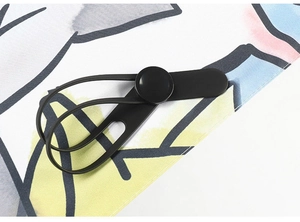 Detail of cute cat printed umbrella with black elastic buckle and durable fabric texture