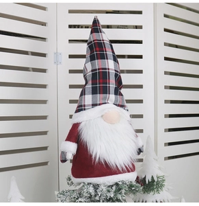 Close-up of a Christmas gnome topper with a tall plaid hat and long white beard decor