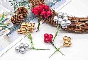 Close-up of decorative red gold and silver Christmas berry stems for holiday wreath making
