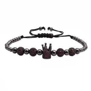 Detailed view of crown charm beaded bracelet with purple zircon and adjustable cord
