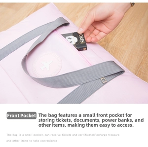 Close-up of the front zipper pocket on a pink foldable travel bag for small items
