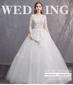 Dettaglio dell'abito da sposa bianco a maniche lunghe con ricami in pizzo e tessuto in rete