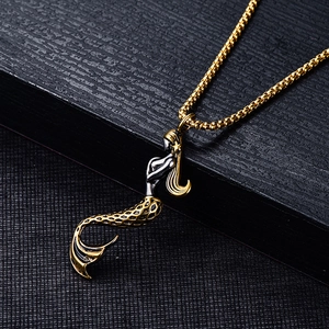 Titanium steel golden mermaid pendant necklace on a dark textured display box