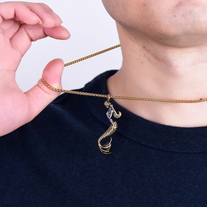 Minimalist gold mermaid pendant necklace in stainless steel shown on male model neck