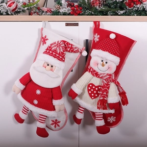 Large festive knit Christmas stockings featuring Santa and Snowman characters for gift storage