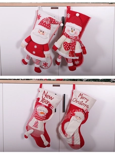 Detail of four festive red and white Christmas stockings with 3D Santa and Snowman figures