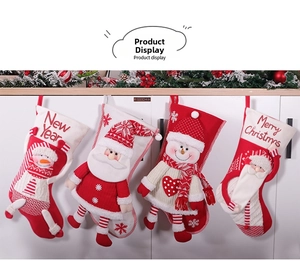 Close-up of 3D Santa and Snowman plush figurines on large knitted Christmas stockings