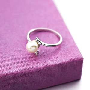 Elegant 18k gold plated silver ring with a white pearl and zircon on purple box