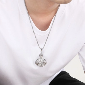 Detailed view of Saint Jude religious pendant on box chain worn by male model