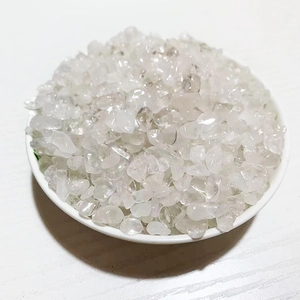 Macro shot of natural clear crystal stone chips in a white dish on wood background