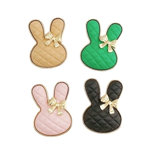 Cartoon rabbit charm accessories with checkered patterns and golden bows in four colors