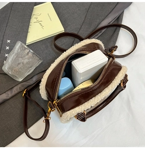 Detail view of the plush pillow bag interior with daily makeup items in warm tones